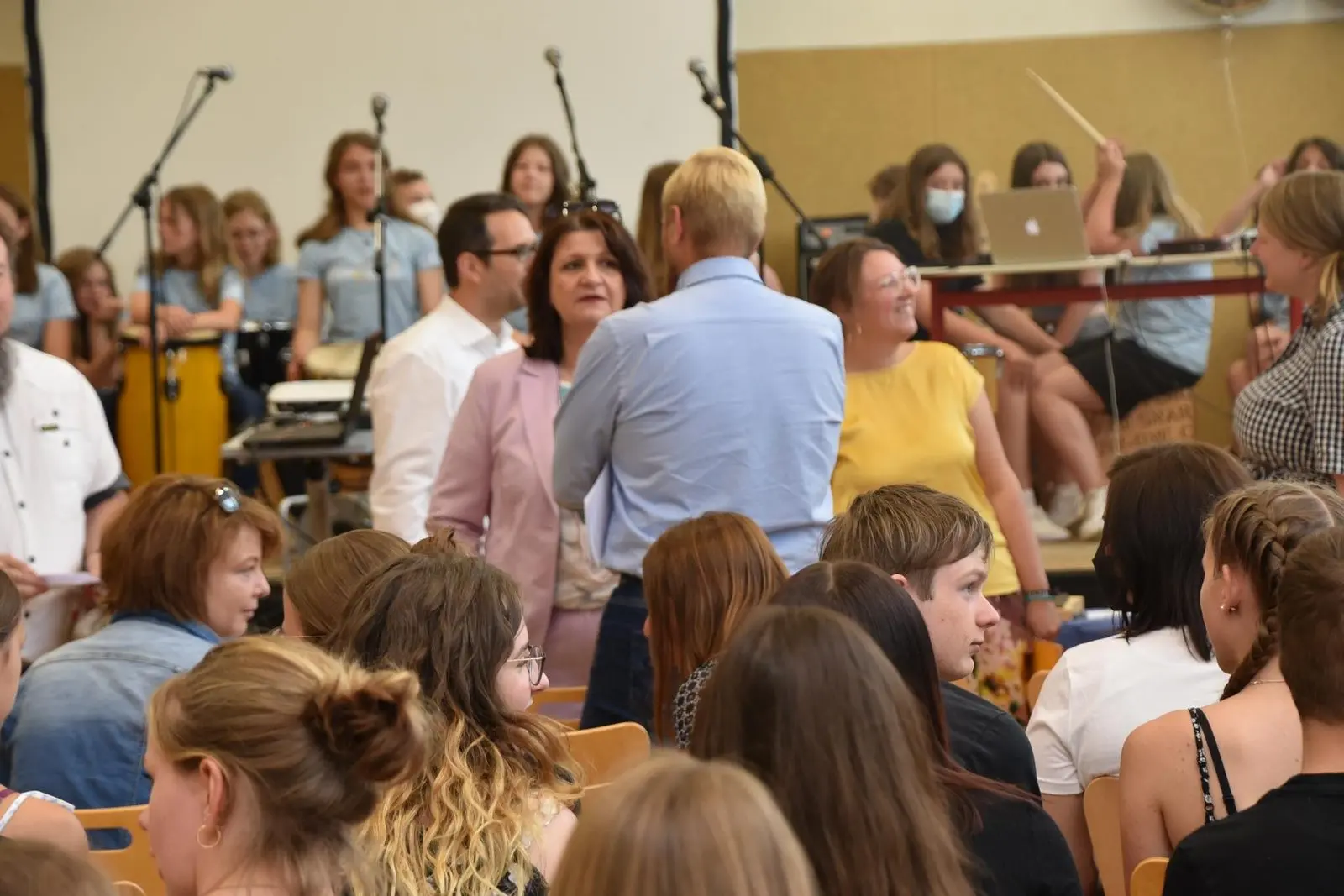 Gäste im Gespräch vor der Musikklasse in der Sporthalle