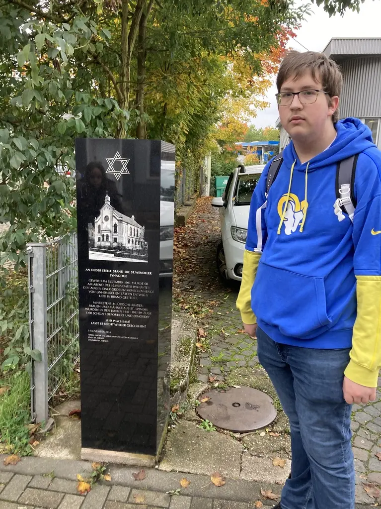 Jugendlicher neben einer schwarzen Gedenkstele zur ehemaligen St. Wendeler Synagoge